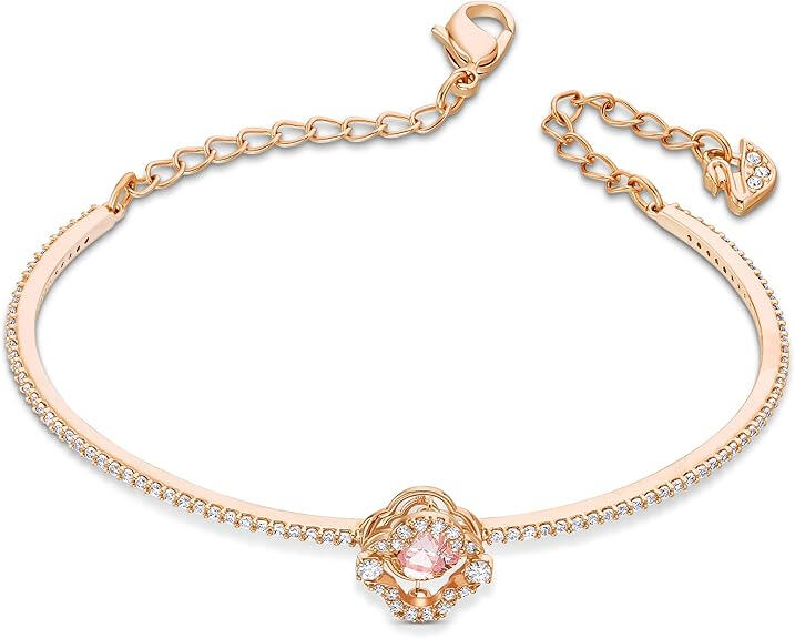 Swarovski clover-motif bangle on neutral surface